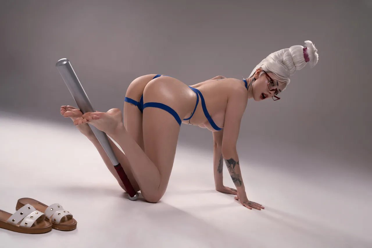 Blonde Babe in Blue Lingerie and Glasses on All Fours with Baseball Bat Hot blonde babe in blue lingerie and glasses on all fours with a baseball bat, showcasing a beautiful bare butt and arched back.