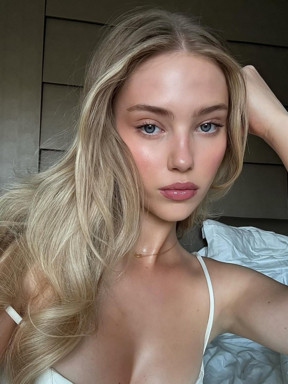 Blonde Beauty with Captivating Blue Eyes Blonde beauty with captivating blue eyes and a hint of cleavage, inviting desire.