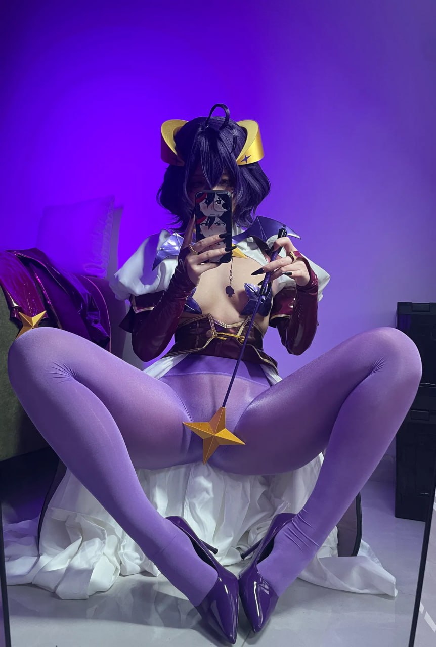 Cosplay Babe Spreads Legs in Purple Pantyhose Purple-clad cosplay babe in pantyhose and high heels, spreading her legs for a perfect shot.