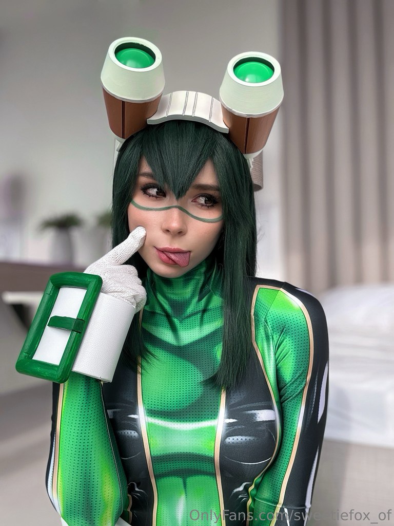 My Hero Academia Tsu Asui Cosplay with Seductive Tongue Out Hot My Hero Academia Tsu Asui cosplay with seductive tongue out pose and tight green bodysuit.