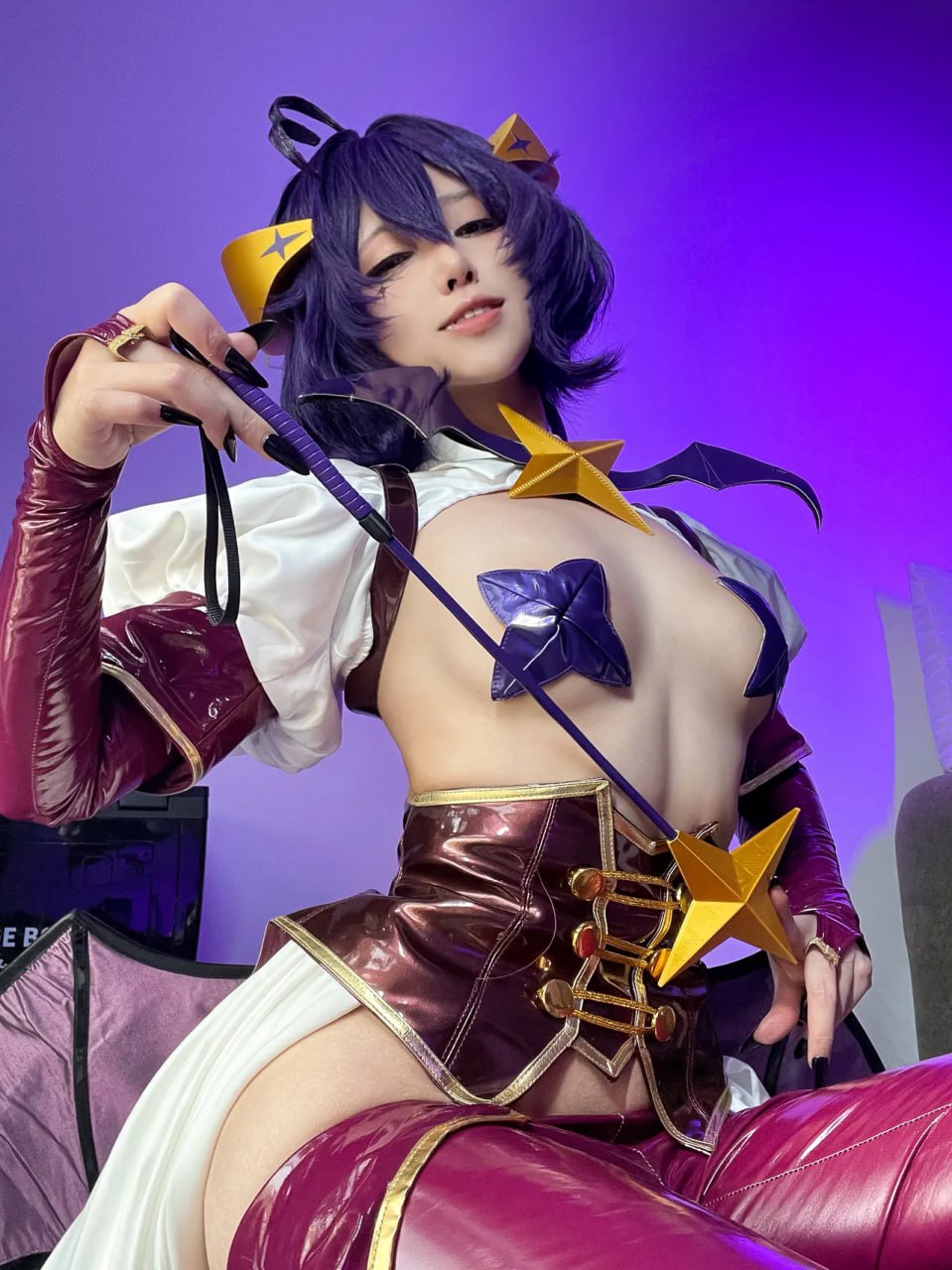 Sexy Cosplay Babe with Nipple Pasties in Revealing Costume Purple-haired cosplay babe in revealing outfit with nipple pasties and a whip-like accessory.